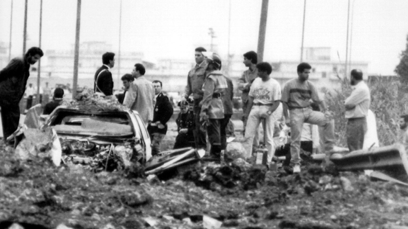 Gli investigatori sul luogo della strage  del  23 maggio 1992, sull'autostrada A29, nei pressi dello svincolo di Capaci nel territorio comunale di Isola delle Femmine, a pochi chilometri da Palermo, dove morirono il magistrato antimafia Giovanni Falcone, sua moglie Francesca Morvillo e tre agenti della scorta, Vito Schifani, Rocco Dicillo, Antonio Montinaro. Gli unici sopravvissuti furono gli agenti Paolo Capuzza, Angelo Corbo, Gaspare Cervello e l'autista giudiziario Giuseppe Costanza ANSA
