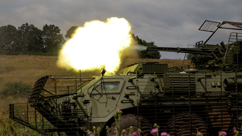 FILE PHOTO: Service members of the 58th Separate Motorized Infantry Brigade of the Ukrainian Armed Forces fire a cannon of a BTR-4 armoured personnel carrier during military exercises at a training ground, in Kharkiv region, Ukraine, August 11, 2025. REUTERS/Sofiia Gatilova/File Photo